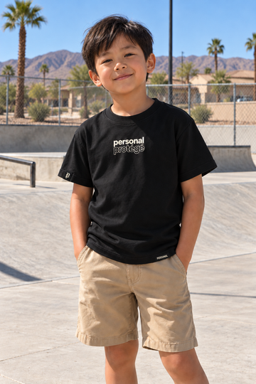 Personal Protégé Kids Tee — front view at a desert skatepark